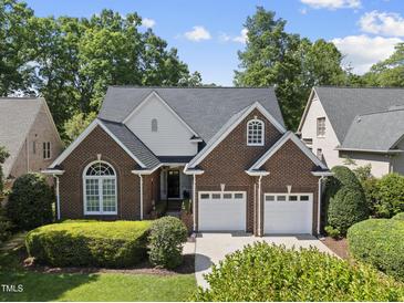 Charming brick home with a two-car garage and well-manicured landscaping in a suburban setting at 156 Yorkchester Way, Raleigh, NC 27615