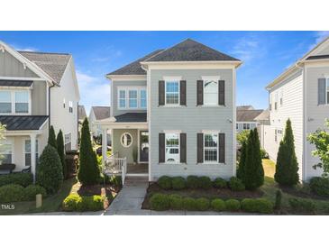 Charming two-story home featuring gray siding, dark shutters, and a landscaped front yard at 1641 Silo Ridge Dr, Wake Forest, NC 27587