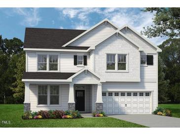 Charming two-story home with shingle accents, dark shutters, well maintained lawn, and two-car garage at 1891 Ballard Rd # 192, Fuquay Varina, NC 27526