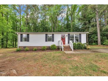 Charming single-story home featuring white siding, black shutters, and a welcoming red front door at 196 Marlin Ln, Smithfield, NC 27577