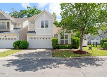 Charming two-story home with a well-manicured lawn and attached two-car garage at 207 Bell Tower Way, Morrisville, NC 27560