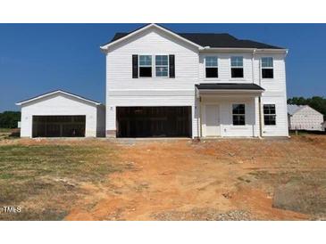 New two-story home with white siding, black shutters, a two-car garage, and a detached single-car garage at 22 Sagamore Avenue, Angier, NC 27501