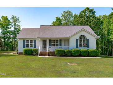 Charming single-story home featuring green shutters and manicured front yard shrubbery at 318 Duck Pond Ln, Clayton, NC 27520
