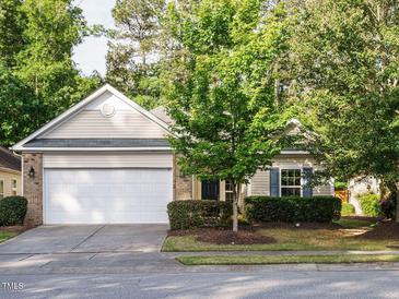 Charming single-Gathering home featuring a spacious two-car garage, manicured lawn, and mature trees at 33 Juliette Dr, Durham, NC 27713