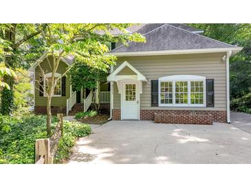 Charming home featuring a welcoming entrance with a white front door and manicured landscaping at 4713 Little Falls Dr, Raleigh, NC 27609