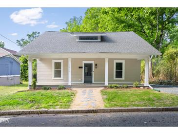 Charming home featuring a covered porch with white columns and a landscaped front yard at 1010 Cobb St, Durham, NC 27707