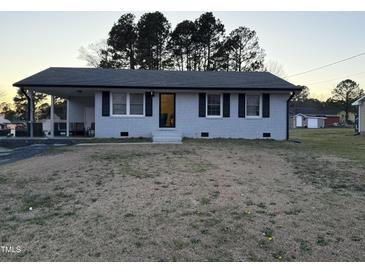 Charming single-story home with a covered carport and inviting entrance at 109 Pine St, Dunn, NC 28334