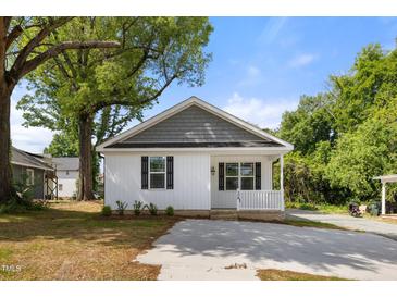 Charming single-story home featuring a welcoming porch and a new driveway at 208 W Holt St, Burlington, NC 27217