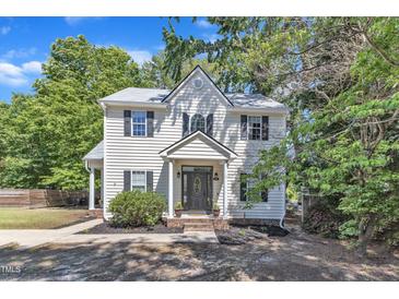 Charming two-story home with classic architectural details, manicured landscaping, and a welcoming front porch at 24 W Canterbury Ct, Wendell, NC 27591