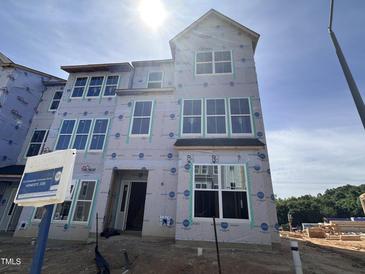 New construction home with large windows awaiting finishing touches and landscaping at 331 Chesapeake Cmns St # 106, Garner, NC 27529