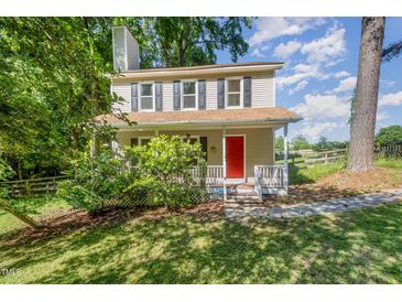 Charming two-story home featuring a bright red front door and covered porch at 40 Crepe Myrtle Ct, Angier, NC 27501