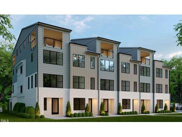Modern townhome with gray siding, white brick, large windows, and a private balcony at 410 Chatham View Rd, Cary, NC 27511
