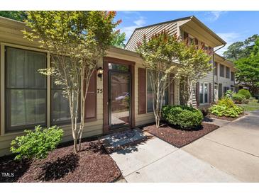 Inviting front entrance with a glass door and neutral toned exterior with tasteful landscaping at 75 Stone Hill Ct, Durham, NC 27704