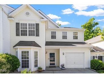 Charming two-story home with white siding, a well-manicured lawn, and an attached garage at 1 Edgebrook Cir, Durham, NC 27703