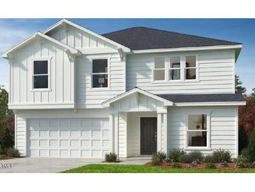 Charming two-story home features a two-car garage, neutral paint, and well-manicured lawn at 147 Gobbler Dr, Smithfield, NC 27577