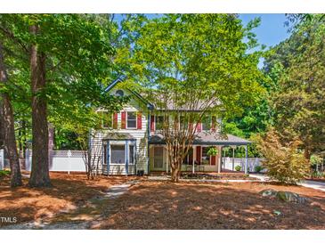 Charming two-story home with mature trees and a well-manicured lawn at 1816 Albacore Ln, Raleigh, NC 27612