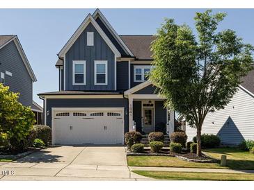 Charming two-story home featuring a two-car garage, landscaped front yard, and covered front porch at 1941 Bright Kannon Way, Wendell, NC 27591