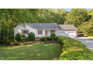 Charming single Gathering home featuring a manicured lawn and a 2-car attached garage at 205 Smiths Creek Dr, Clayton, NC 27520