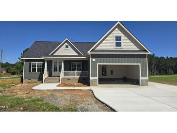 Charming home featuring a two-car garage, covered porch and craftsman style architecture at 25 Sanders Farm Dr, Smithfield, NC 27577