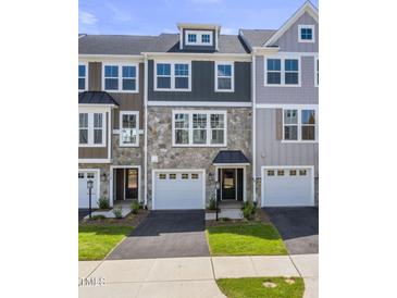 Charming new construction townhomes with stone accents, attached garages, and professionally landscaped lawns at 509 Sherron Rd # 30, Durham, NC 27703