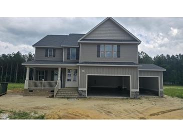 New construction two-story home featuring attached two-car garage, gray siding, and inviting front porch at 66 Sanders Farm Dr, Smithfield, NC 27577