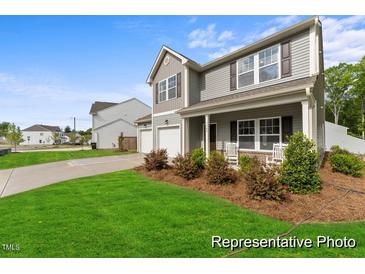 Charming two-story home with well-manicured lawn and inviting front porch, a perfect blend of comfort and style at 69 Curling Creek Dr # I286, Clayton, NC 27527