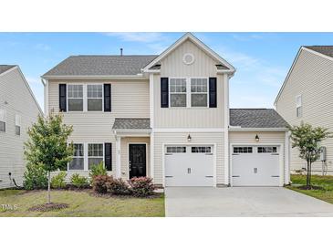 Charming two-story home featuring a two-car garage, black shutters, and well-maintained landscaping at 69 Curling Creek Dr # I286, Clayton, NC 27527