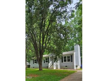 Charming single-story home with a classic gray exterior, white trim, and a welcoming front porch at 81 Honeysuckle Dr, Pittsboro, NC 27312
