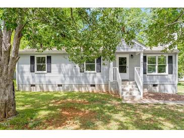 Charming single-story home featuring a well-maintained lawn and inviting front porch at 81 Honeysuckle Dr, Pittsboro, NC 27312