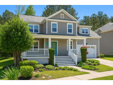 Inviting two-story home with a charming front porch, landscaped yard, and a gray-shingled exterior at 102 Kipling Dr, Oxford, NC 27565