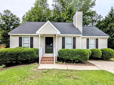 Charming home with a well-manicured lawn and neatly trimmed hedges adding to its curb appeal at 106 Grange Dr, Wendell, NC 27591