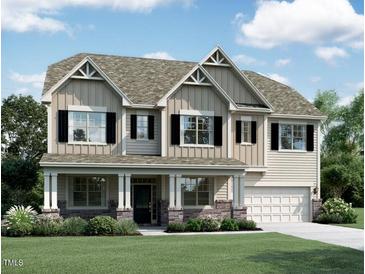 Charming two-story home with a welcoming front porch, stone accents, and lush landscaping at 1317 Sparkling Lake Dr # 40, Apex, NC 27523