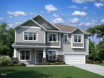 Charming two-story home showcasing traditional architecture, manicured lawn, and a two car garage at 1321 Sparkling Lake Dr # 41, Apex, NC 27523
