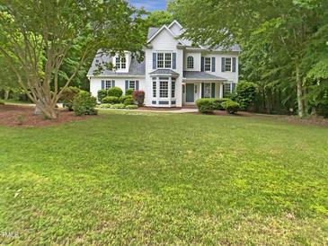 Charming two-story home with a manicured lawn and mature trees enhancing curb appeal at 150 Remington Ct, Youngsville, NC 27596