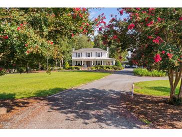 Charming two-story home with a front porch and mature trees at 3123 Brassfield Rd, Creedmoor, NC 27522
