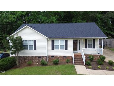 Charming single story home with bright siding, neat landscaping, and a welcoming front porch at 400 Southerby Dr, Garner, NC 27529