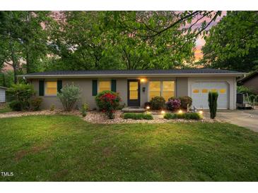 Charming one-story home with landscaped front yard, flowerbeds, and a one car garage at 509 Stokes Rd, Graham, NC 27253