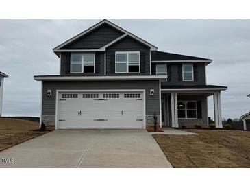 Charming two-story home with a wide driveway and a two-car garage at 111 High Hampton Way, Fuquay Varina, NC 27526