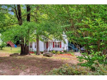 Charming two-story home with landscaped yard and mature trees offering privacy at 135 Crooked Creek Run, Louisburg, NC 27549