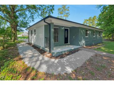 Charming single-story home featuring a freshly painted exterior and a cozy front porch at 308 Lynn Road, Durham, NC 27703