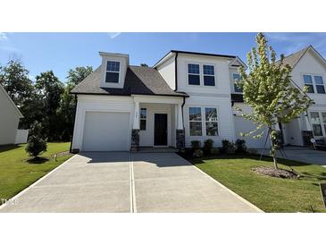 Beautiful new construction home featuring a modern design with white siding and a well-manicured lawn at 367 Whitley Ridge Dr, Clayton, NC 27527