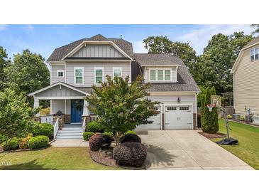 Beautiful two-story home with manicured lawn, two-car garage, and a classic craftsman-style front porch at 4562 Brighton Ridge Dr, Apex, NC 27539