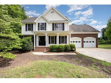 Charming two-story home featuring a covered porch and a two-car garage at 84 Sycamore Lake Rd, Siler City, NC 27344