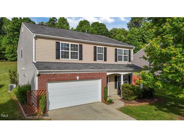 Charming two-story home with brick accents, a two-car garage, and manicured landscaping at 1301 Torrey Pines Ct, Mebane, NC 27302