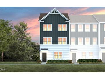 Charming townhome showcasing a modern design and inviting front entrance and manicured lawn at 1482 Hasse Ave, Apex, NC 27502