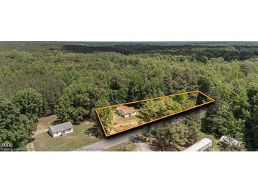 A peaceful property featuring a cozy home surrounded by lush greenery and natural beauty at 3899 Warrenton Rd, Henderson, NC 27537
