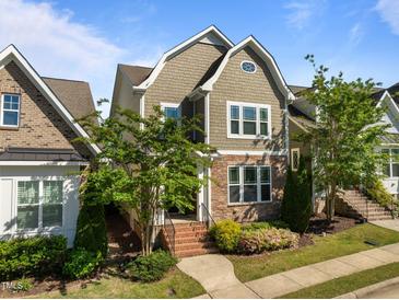Charming two-story home with stone accents, mature landscaping, and inviting brick stairs leading to the entrance at 49 Salt Cedar Ln, Chapel Hill, NC 27516