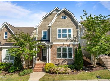 Charming home with a stone facade, complemented by manicured landscaping and a welcoming entrance at 49 Salt Cedar Ln, Chapel Hill, NC 27516