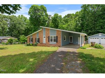 Charming single-story home featuring a combination of brick and siding, complemented by a well-maintained front yard at 5652 Laurel Crest Dr, Durham, NC 27712