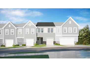 A modern two-story townhome featuring a single-car garage and traditional architectural elements at 6018 Grey Colt Way, Durham, NC 27703